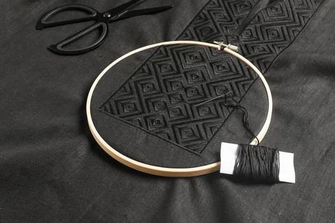 Embroidery hoop, thread and scissors on black shirt. Ukrainian national cloth Foto stock