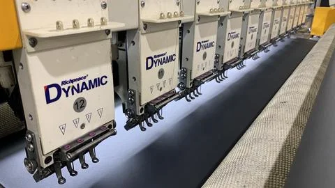 Embroidery machine precision for textile design and manufacturing Stock Photos