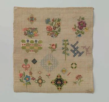 Embroidery patch of beige tinted linen. The embroidery has Petit Point wit... Stock Photos