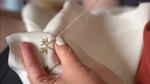 Embroidery techniques on fabric showcasing delicate handwork Stock Footage 318903715