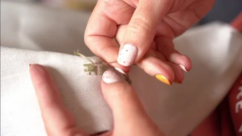 Embroidery techniques on fabric showcasing delicate handwork Stock Footage 327059826