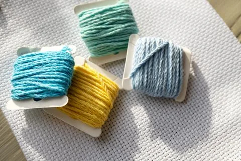 Embroidery threads on canvas Stock Photos