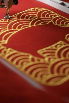 Embroidery of traditional shell pattern and stitched pig outline with gold on Stock Photos