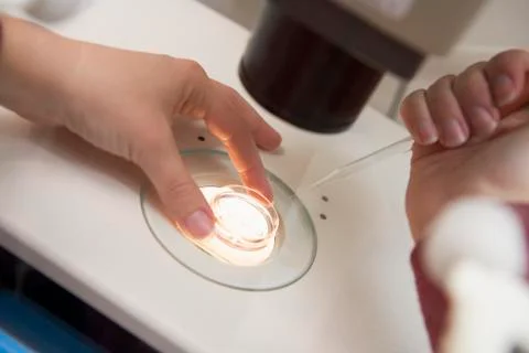Embryologist adding sperm to egg Stock Photos