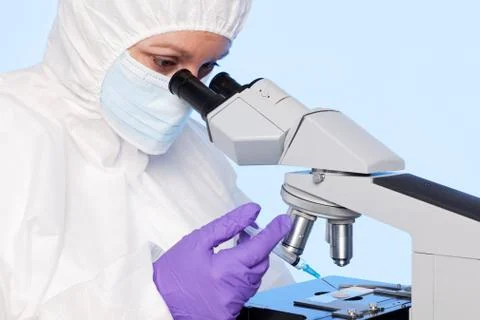 Embryologist extracting a sample using a syringe. Stock Photos