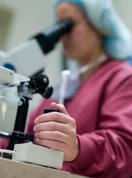 Embryologist with microscope performing an intra cytoplasmic sperm injection Stock Photos