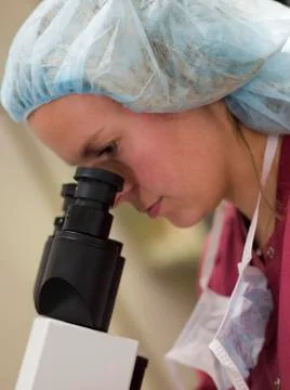 Embryologist with microscope performing an intra cytoplasmic sperm injection Stock Photos