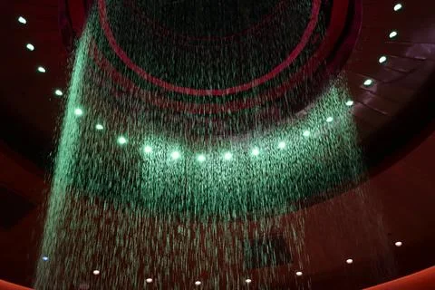Emerald Cascade: Indoor Circular Waterfall with Green Lighting Stock Photos