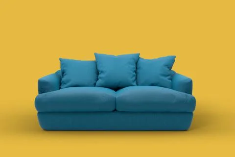 Emerald couch with pillows on studio yellow background. Stock Photos