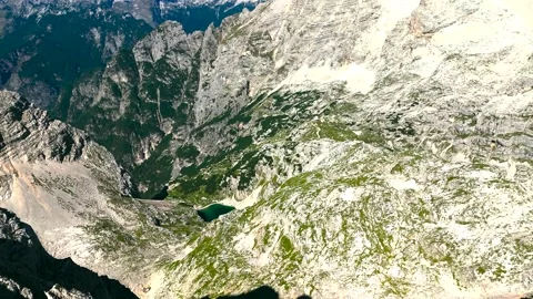 Emerald glacial tarn on the high karst of the Julian Alps Stock Footage 346642611
