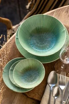 Emerald Green Ceramic Dinnerware Set with Radial Texture on Wood Table Stock Photos