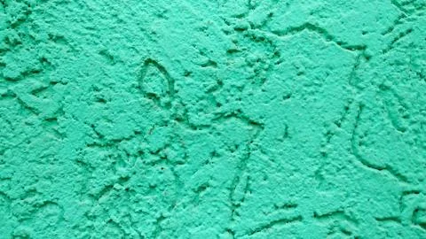 Emerald green wall with patterned plaster paint background Stock Photos