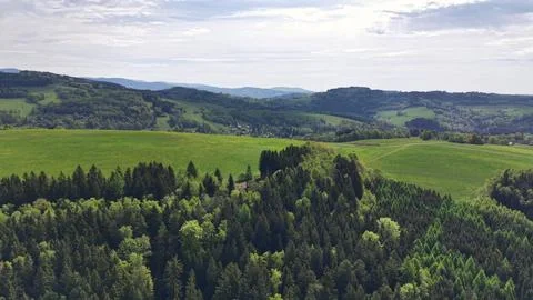 Emerald hills roll across patchwork farmland with scattered villages and fo.. Stock Photos