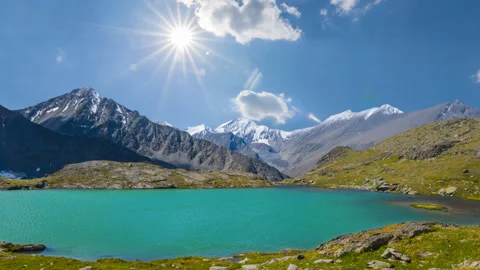 Emerald lake in the mountain valley under a sparkle sun Stock Footage 261155259