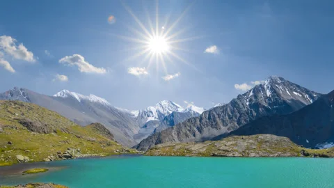 Emerald lake in the mountain valley under a sparkle sun Stock Footage 332799415
