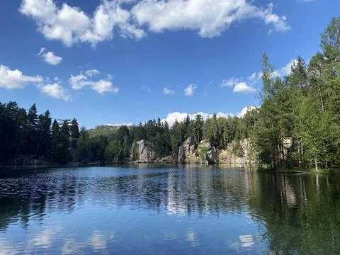 Emerald Lake Surrounded by Cliffs and Forest Stock Photos