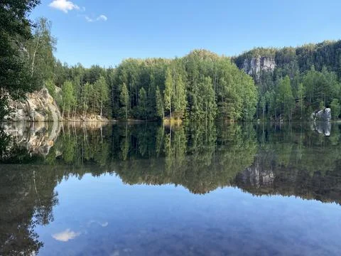 Emerald Lake Surrounded by Cliffs and Forest Stock Photos