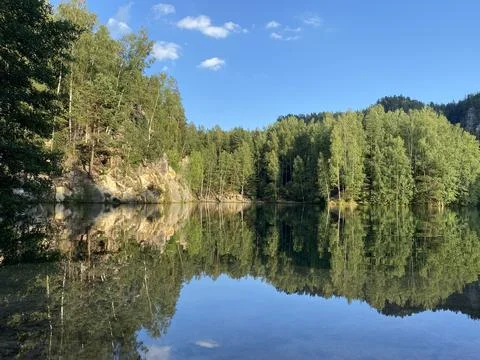 Emerald Lake Surrounded by Cliffs and Forest Stock Photos