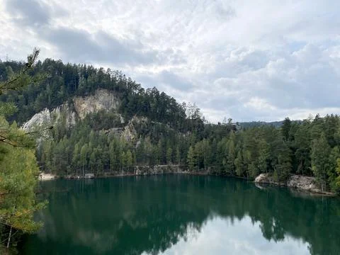Emerald Lake Surrounded by Cliffs and Forest Stock Photos