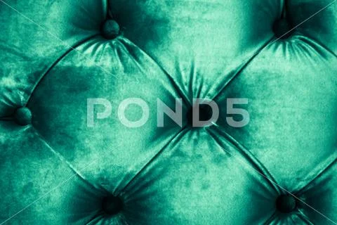 Emerald luxury velour quilted sofa upholstery with buttons, elegant green hom Stock Photos