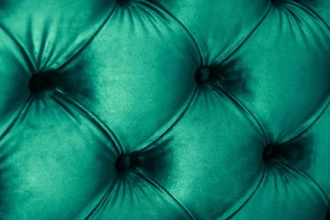 Emerald luxury velour quilted sofa upholstery with buttons, elegant green hom Stock Photos