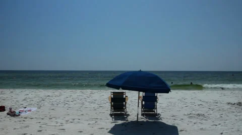 Emerald ocean white sand beach with beach activity and paraphanalia wide shot 스톡 동영상 33312531