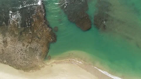 Emerald sea with reefs and waves forming on a tropical beach Stock Footage 311328481