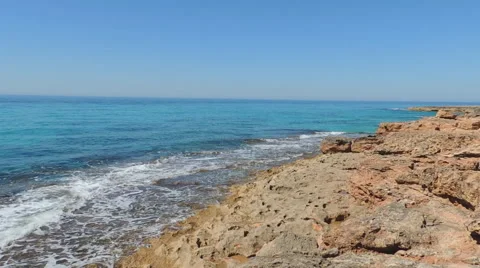 Emerald Sea, Waves Breaking Into Red Rocks Stock Footage 49882493