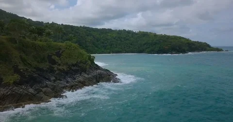 Emerald stormy waves hit the rocks of a beautiful uninhabited island in Phuket Stock Footage 108470041