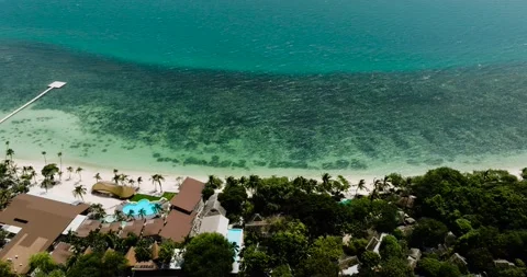 Emerald water and beach with palm trees and resort. Rin Nai Beach. Ko Pha Ngan Stock Footage 318937774