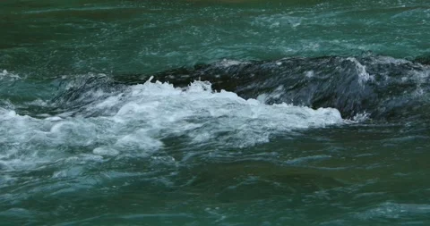 Emerald waters of a mountain river close-up. fast flow of the blue river. Stock Footage 251832912