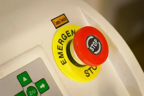 Emercency stop button. Big red button, power switch on industrial machinery. Stock Photos
