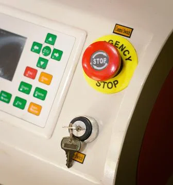 Emercency stop button. Big red button, power switch on industrial machinery. Stock Photos