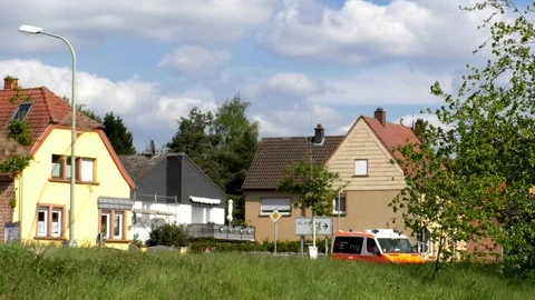 Emergency ambulance driving through small village Otterbach, rural Germany Stock Footage 89306237