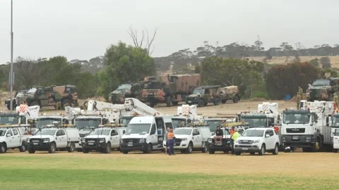 Emergency and army vehicles lined up at oval 動画素材 141236725