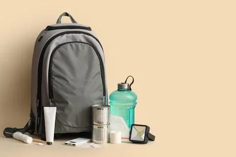 Emergency backpack with necessities on beige background Stock Photos