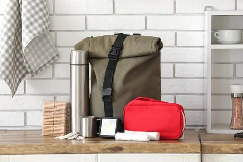 Emergency backpack with necessities on counter in kitchen Stock Photos