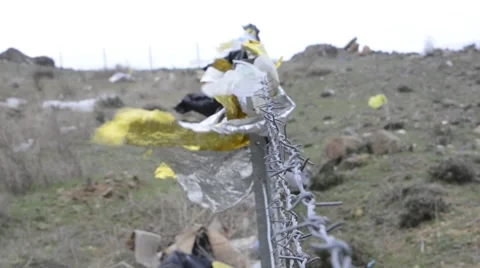 Emergency blankets on barbed wire Stock Footage 62375954
