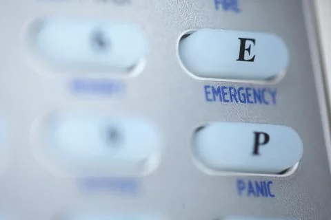 Emergency button of an alarm system keypad Stock Photos