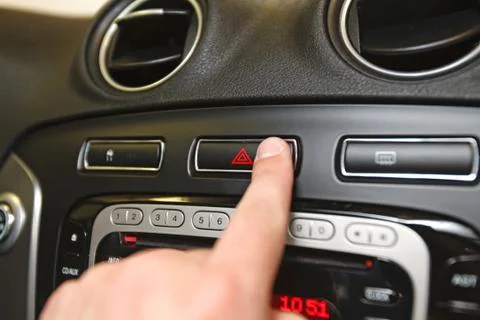 Emergency button on car dashboard Stock Photos