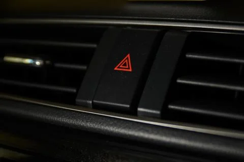 Emergency button close up macro shot on Malaysian car dashboard. Stock Photos