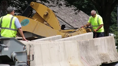Emergency construction services at a disaster site setting up road blocks. Stock Footage 70538353