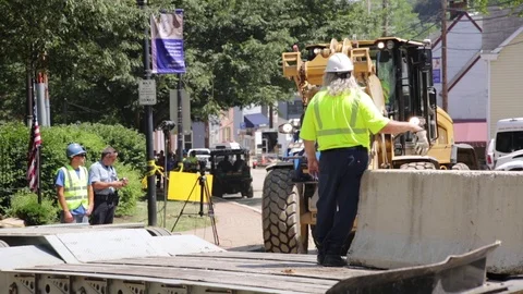 Emergency construction services at a disaster site setting up road blocks. Stock Footage 70538510