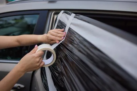 In an emergency, cover broken car window with duct tape for a quick roadsid.. Stockfoto's