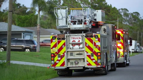 Emergency crew responds to 911 call at single-family house, providing aid. Stock Footage 314786856