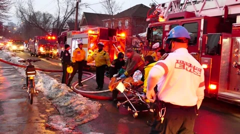 Emergency crews performing CPR while moving a stretcher Stock Footage 48669409