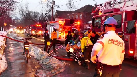 Emergency crews performing CPR while moving a stretcher Stock Footage 77892830