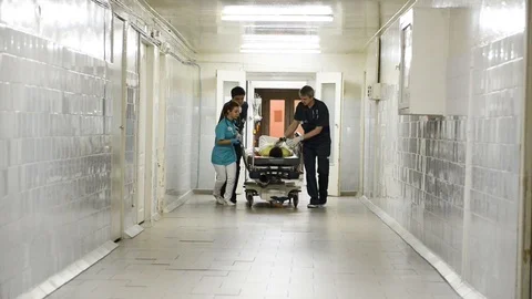 Emergency Department: Doctors, Nurses and Surgeons Move Seriously Injured Stock Footage 101319119