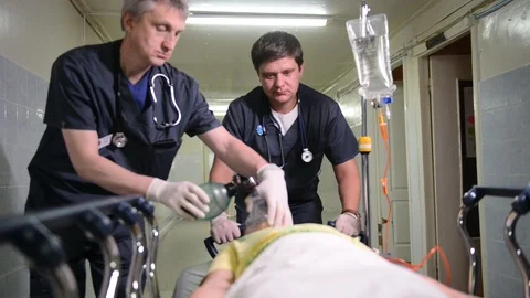 Emergency Department: Doctors, Nurses and Surgeons Move Seriously Injured Stock Footage 101319231