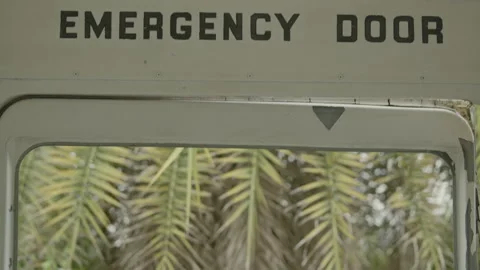 Emergency door with 'Do not Extend Arms From Windows' warning and window view Video stock 347035086